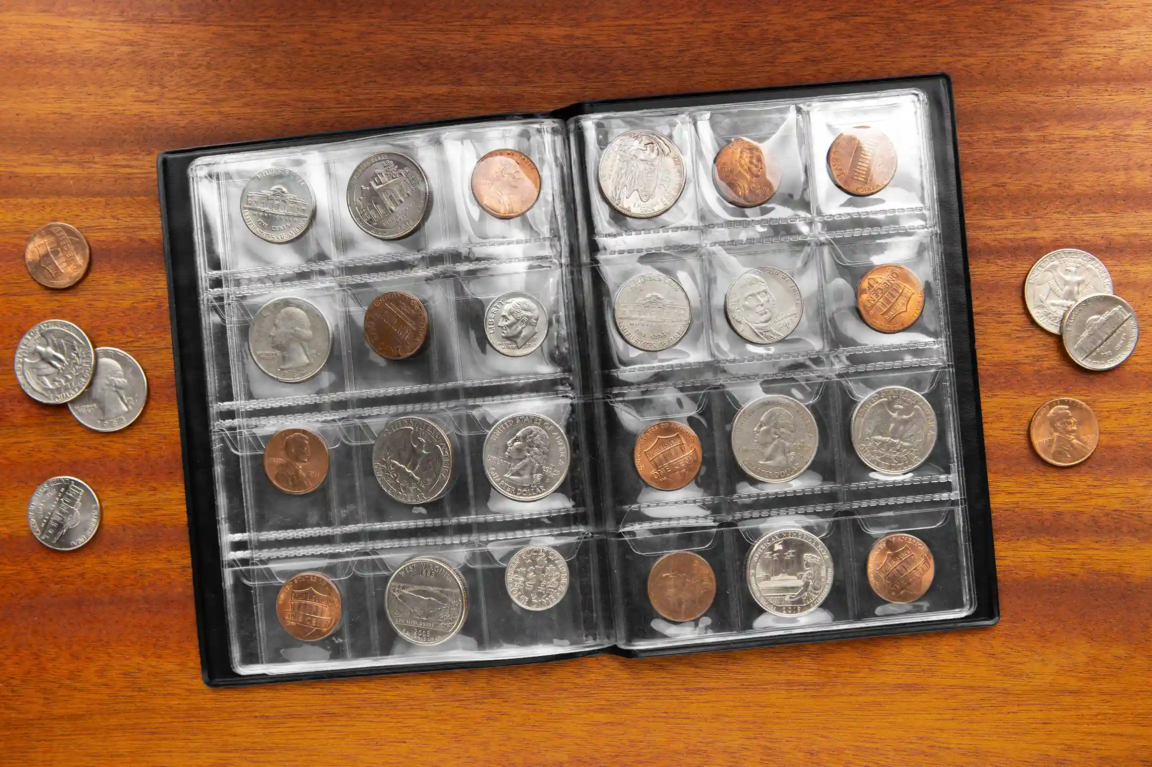  a coin collection in a coin album on a wooden surface